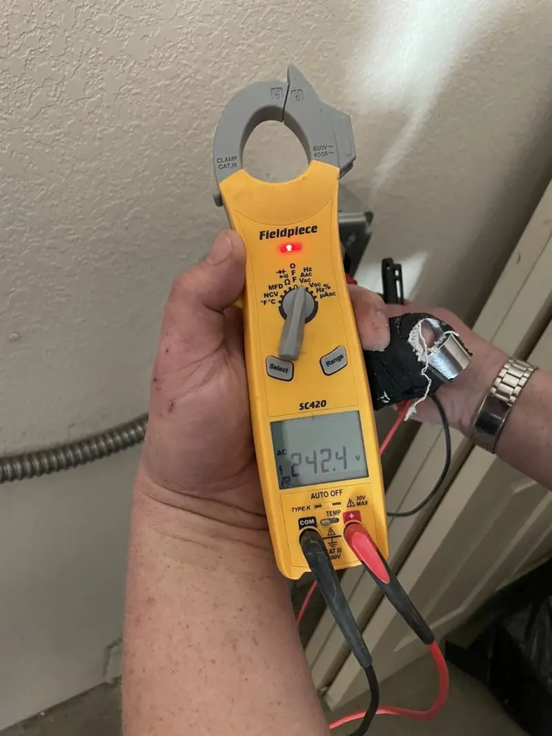 Voltage testing with clamp meter during Recessed Lighting Installation in Mustang